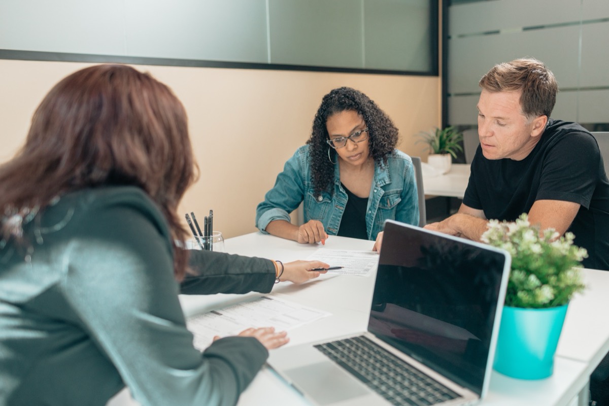Couple reviewing documents with a notary